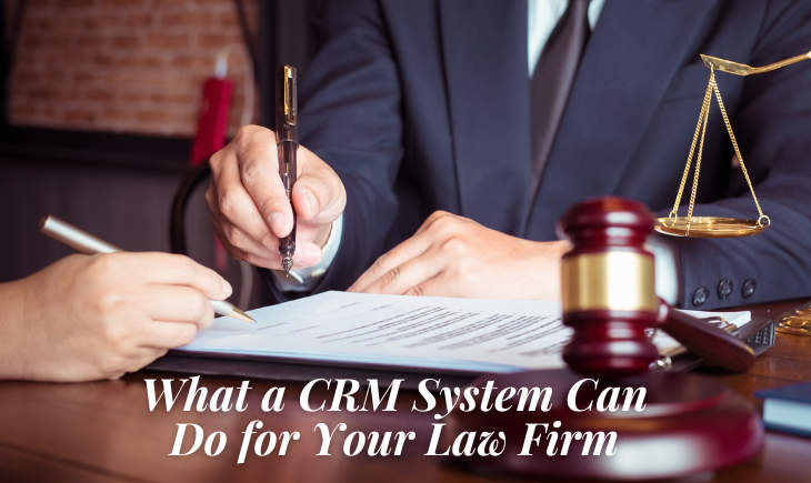 There is an unseen man in a business attire holding up a pen over an important document. There is also another person off-camera preparing to write something on it. There is a gavel and scales of justice beside the man. The title of the article, "What a CRM System Can Do for Your Law Firm," is written below.